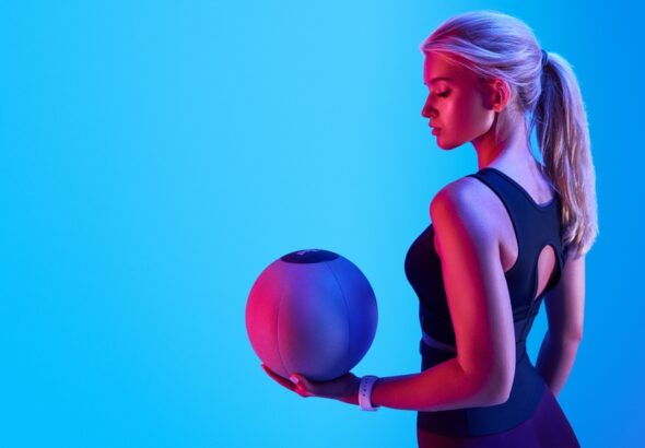 Attractive,Blonde,Sportswoman,Portrait,Holding,With,Medicine,Fitness,Ball,Neon